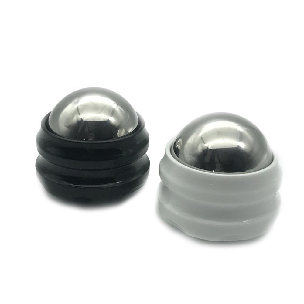 Black and white massage balls for muscle relief and relaxation therapy.