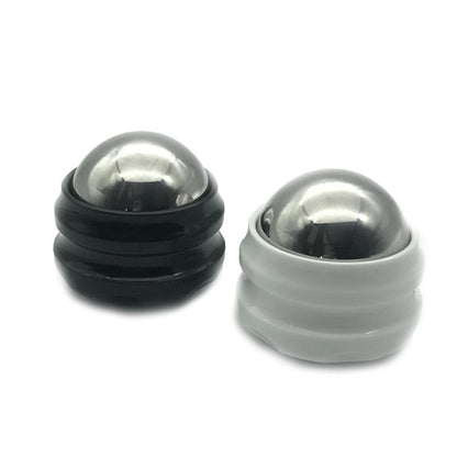 Black and white massage balls for muscle relief and relaxation therapy.