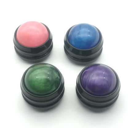 Colorful massage fitness balls in pink, blue, green, and purple for muscle pain relief and stress reduction.