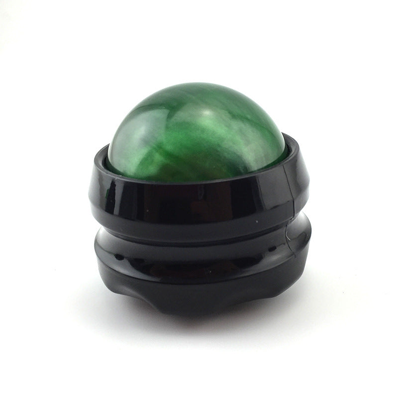 Green massage roller ball in black base for muscle pain relief and relaxation.
