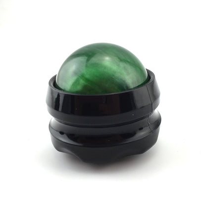 Green massage roller ball in black base for muscle pain relief and relaxation.